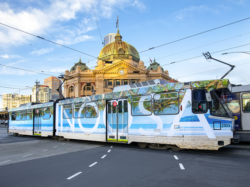 Warm up in Noosa tram wrap design Melbourne